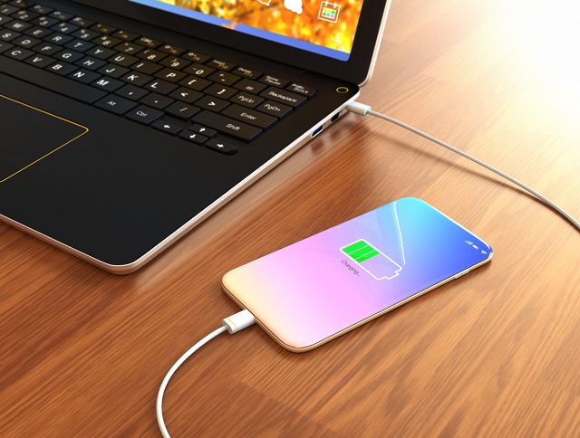 Smartphone charging from laptop computer.
