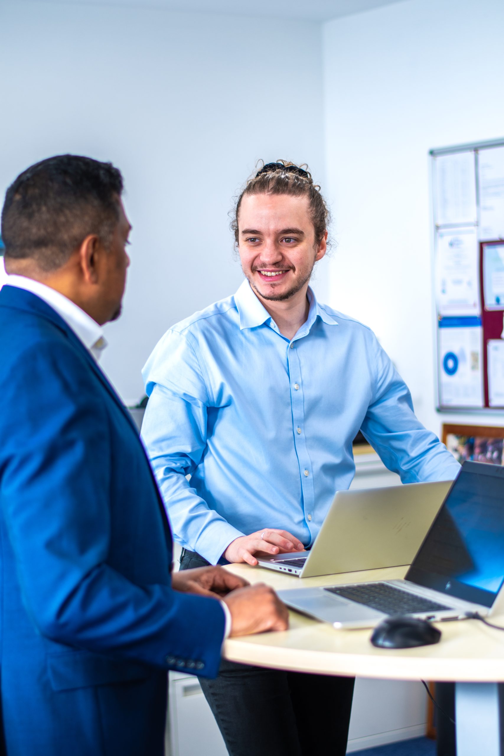 Intersys' Senior Consultant Yacer Sellam with Project Manager Sukan Nair chatting over laptops