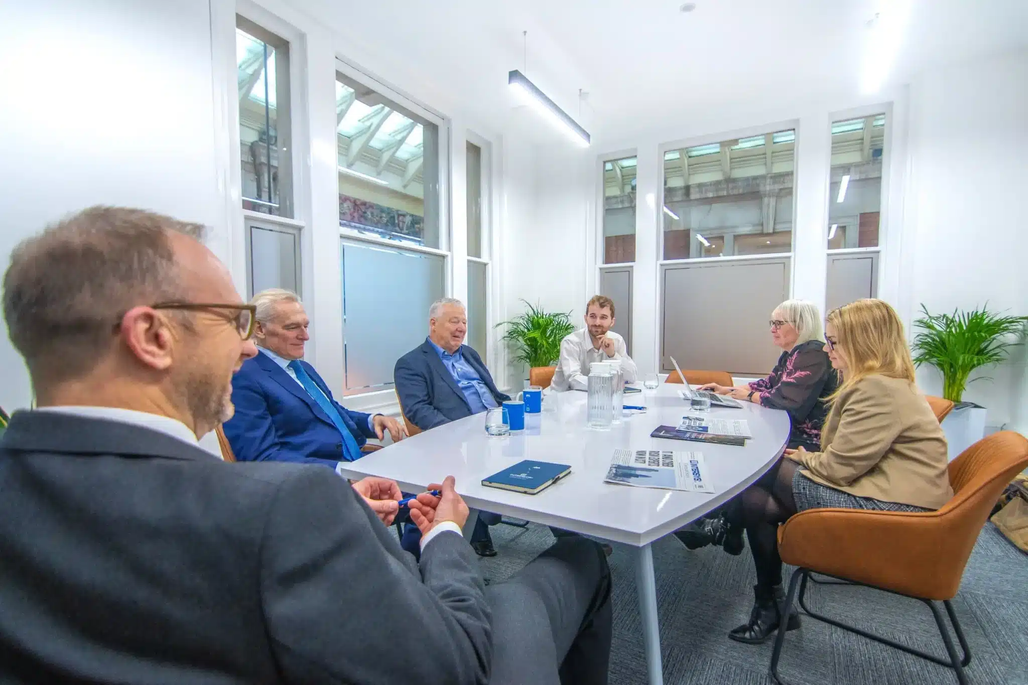 Intersys, a cyber security company in London, gathers to discuss a project: six people pictured around a white table.