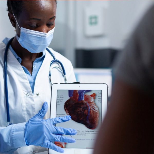 Doctor holding up a tablet with operation details displayed