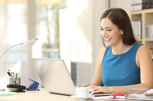 Woman at a laptop, using Microsoft Outlook search tips to locate her emails.